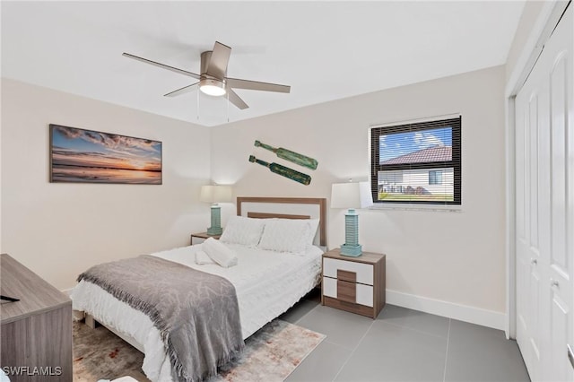 bedroom with ceiling fan, a closet, and light tile patterned floors