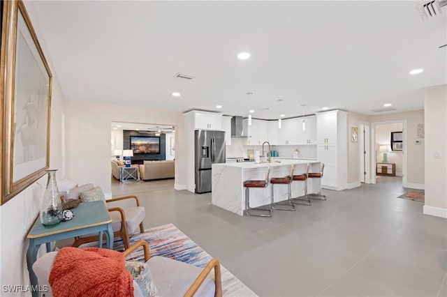 living room featuring sink and ceiling fan