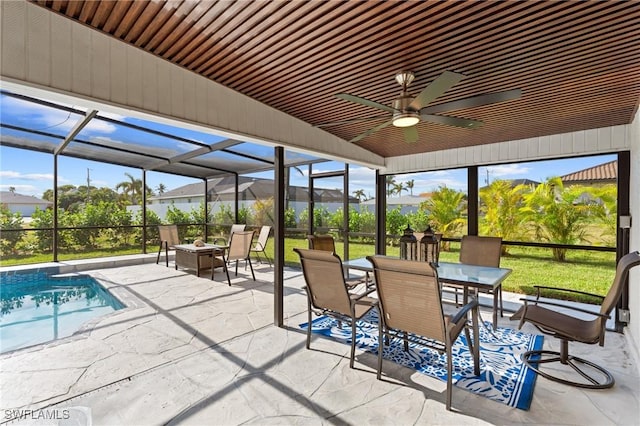 unfurnished sunroom with ceiling fan, lofted ceiling, and a wealth of natural light