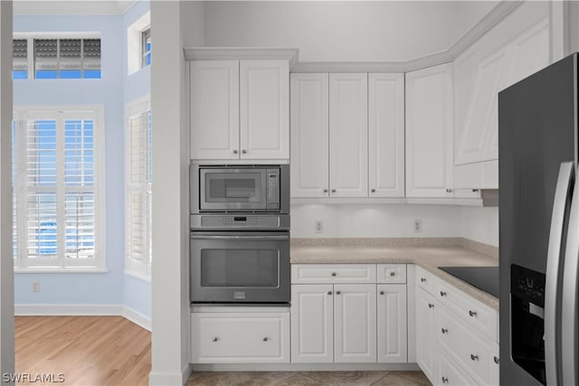 kitchen featuring white cabinets and appliances with stainless steel finishes