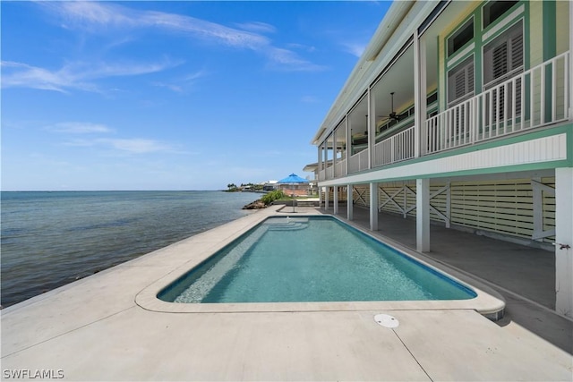 view of pool featuring a water view, ceiling fan, and a patio area