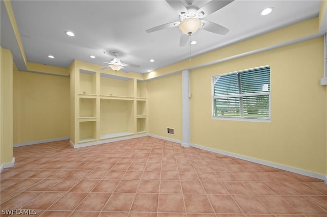 spare room featuring ceiling fan and built in features