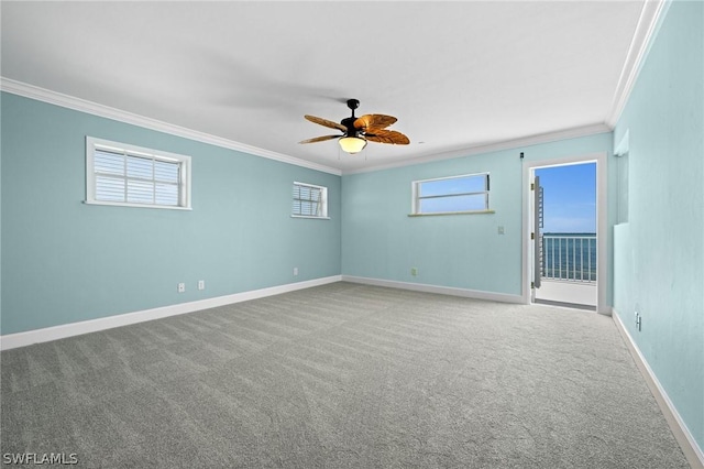 spare room featuring carpet, ceiling fan, and crown molding