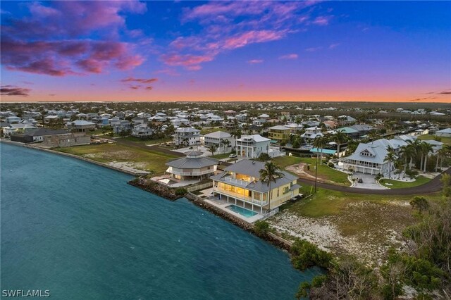 aerial view at dusk with a water view