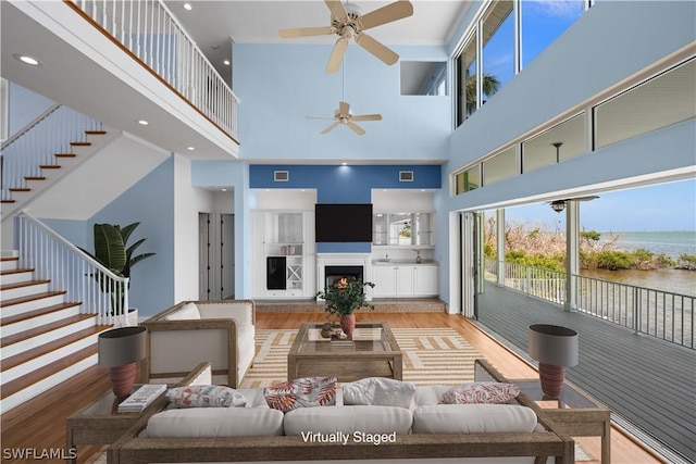 living room featuring a high ceiling and light hardwood / wood-style floors