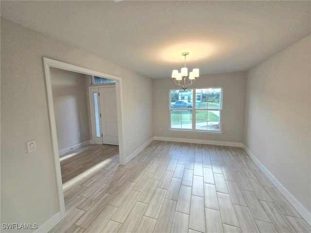 unfurnished dining area with baseboards, a chandelier, and wood tiled floor