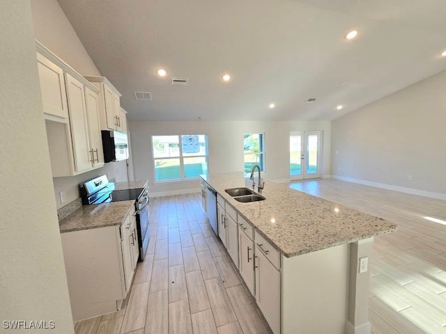 kitchen with a sink, visible vents, white cabinetry, and stainless steel appliances