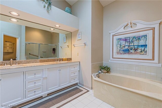 bathroom featuring plus walk in shower, tile patterned floors, and vanity