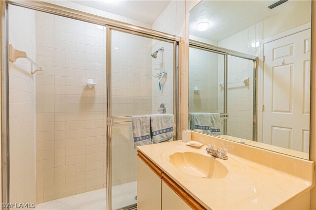 bathroom with an enclosed shower and vanity