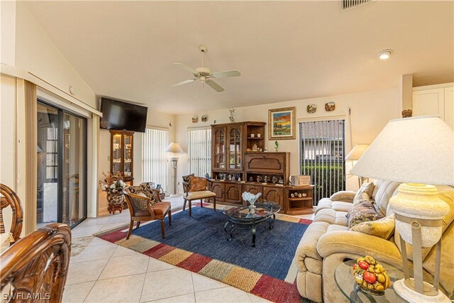 tiled living room with ceiling fan