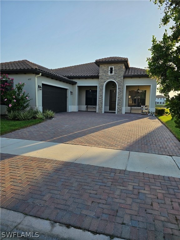 mediterranean / spanish home with a garage