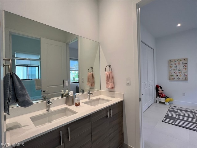 bathroom with dual sinks, tile flooring, and vanity with extensive cabinet space