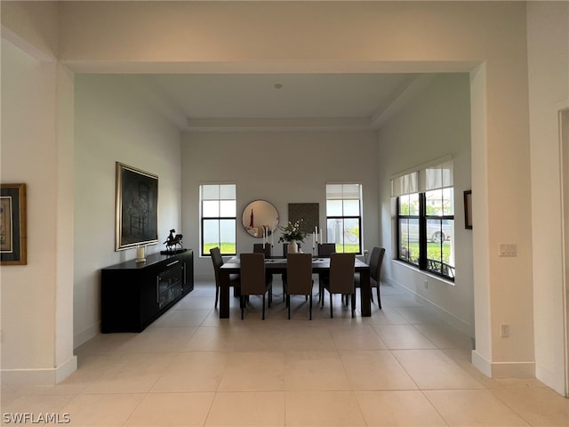 tiled dining space with a high ceiling