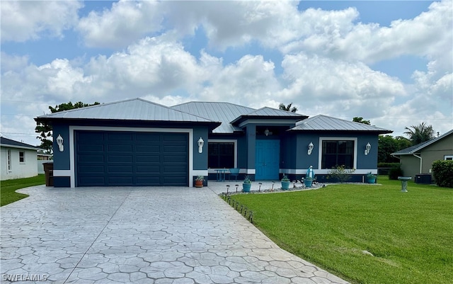 view of front of home featuring central AC unit, a garage, and a front yard