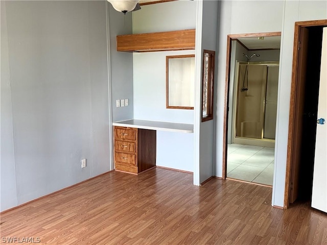 unfurnished bedroom with hardwood / wood-style flooring