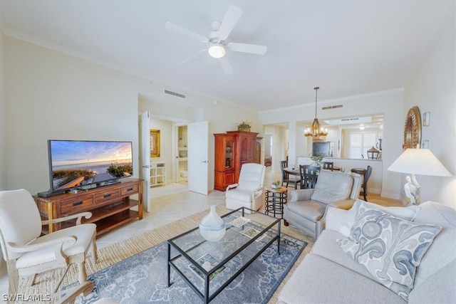 living room featuring tile floors, ornamental molding, and ceiling fan with notable chandelier