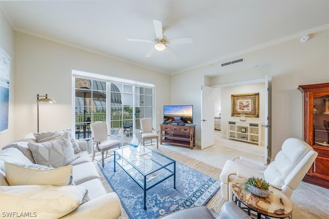 living room featuring tile floors, ceiling fan, and ornamental molding