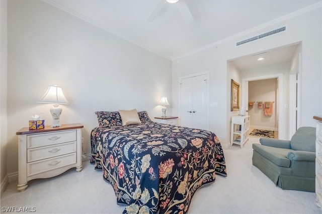 carpeted bedroom featuring ornamental molding, a closet, and ceiling fan