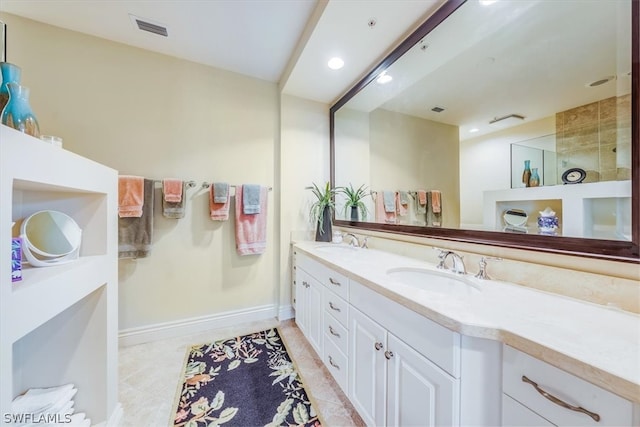 bathroom with dual vanity, walk in shower, and tile flooring