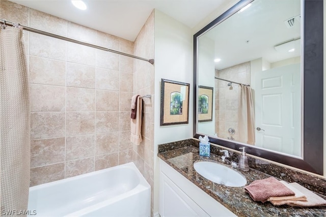 bathroom with shower / bathtub combination with curtain and vanity