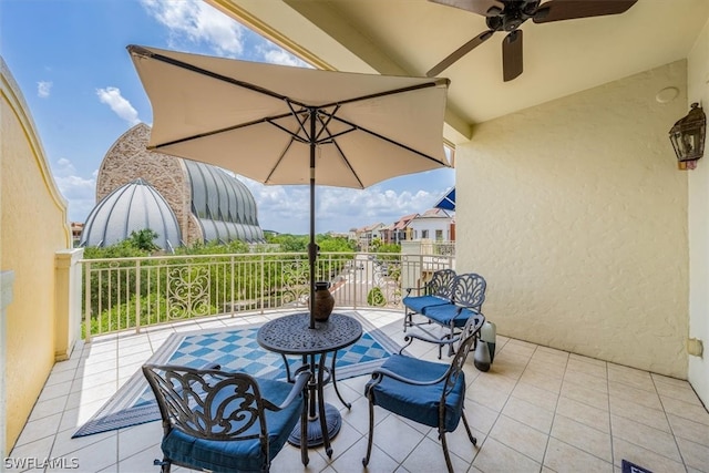 view of patio featuring a balcony and ceiling fan