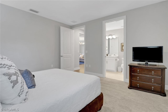 carpeted bedroom with ensuite bathroom