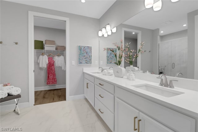 bathroom featuring vanity and a shower with shower door