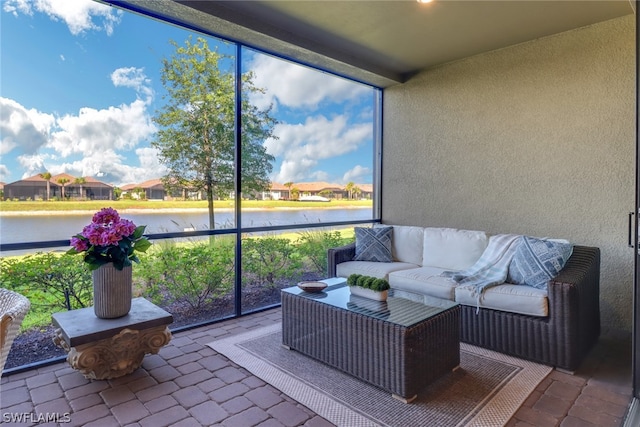 sunroom / solarium with a water view