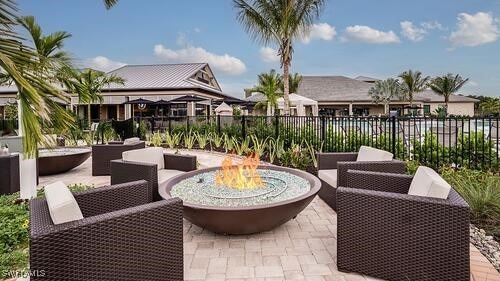 view of patio featuring an outdoor living space with a fire pit