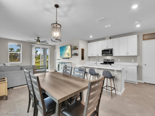 17941 Saddle Rd, Punta Gorda, FL 33982 - dining room featuring ceiling fan, recessed lighting, baseboards, a chandelier, and light tile patterned floors