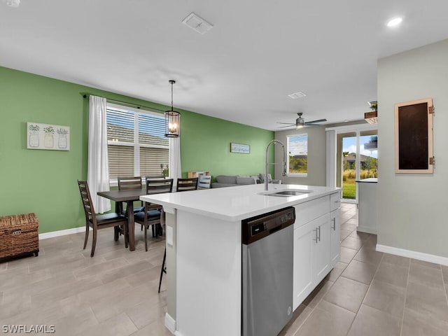 kitchen featuring hanging light fixtures, a center island with sink, white cabinetry, stainless steel dishwasher, and sink