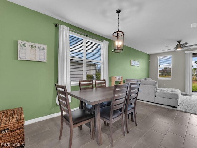 dining space featuring tile floors and ceiling fan