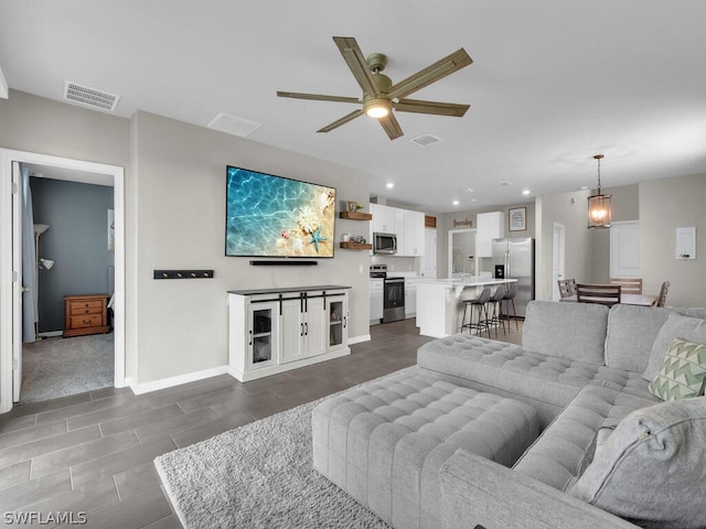 tiled living room featuring ceiling fan