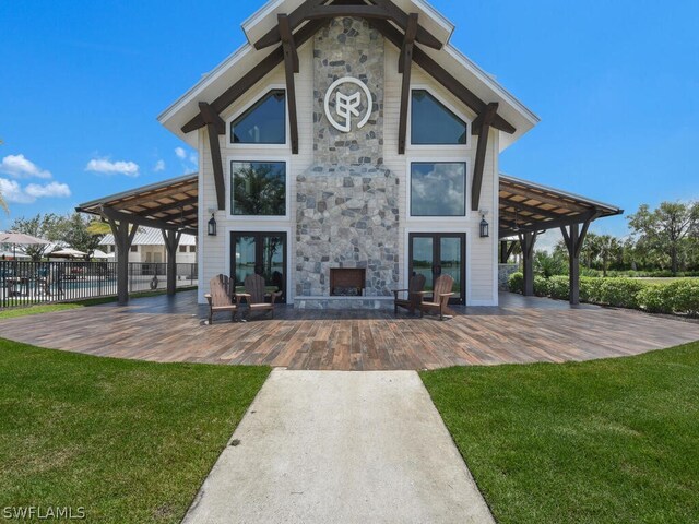 rear view of house with a pergola, a patio, and a lawn