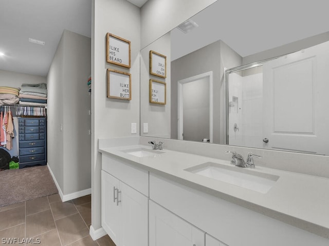 bathroom with tile flooring, double sink vanity, and walk in shower