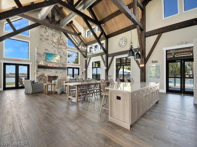 kitchen featuring high vaulted ceiling, beam ceiling, french doors, and dark hardwood / wood-style flooring