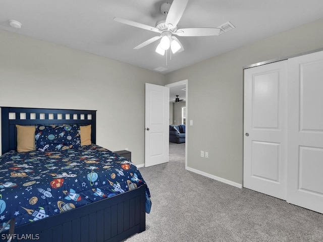 bedroom with a closet, ceiling fan, and carpet floors