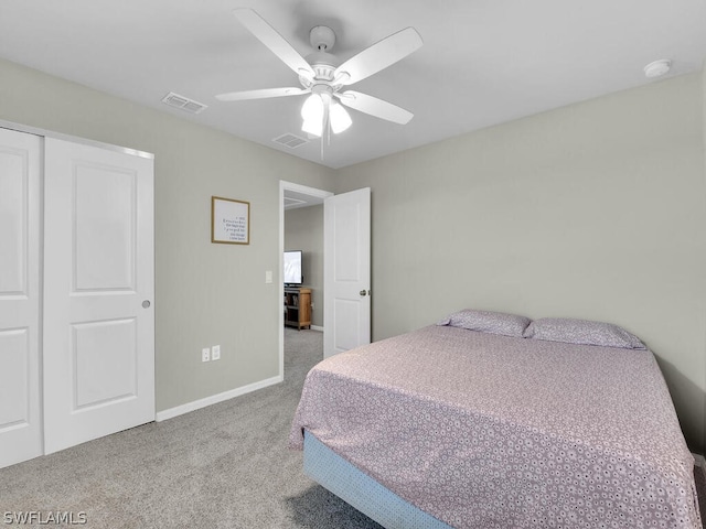 carpeted bedroom with a closet and ceiling fan