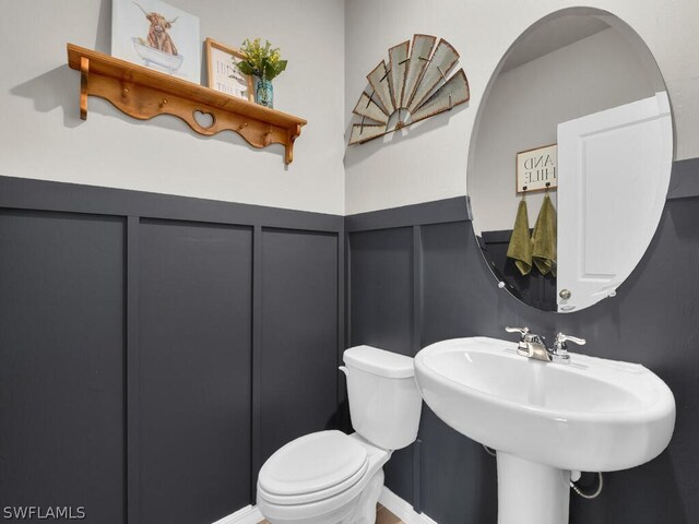 17941 Saddle Rd, Punta Gorda, FL 33982 - half bathroom featuring toilet and a decorative wall