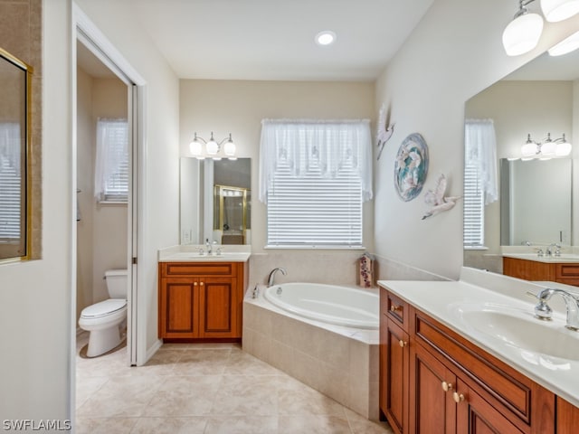 bathroom with toilet, tile patterned floors, a healthy amount of sunlight, and a relaxing tiled tub