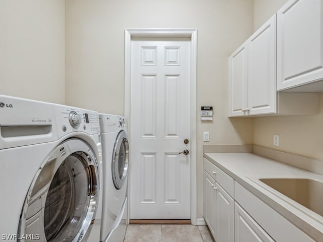 laundry room featuring cabinets, independent washer and dryer, and light tile patterned flooring