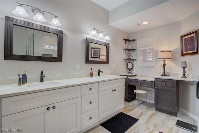 full bath featuring double vanity, wood finished floors, and a sink