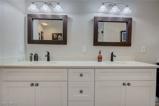 bathroom with a sink and double vanity