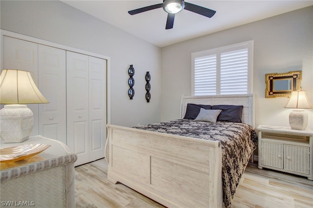 bedroom featuring ceiling fan, light wood finished floors, and a closet