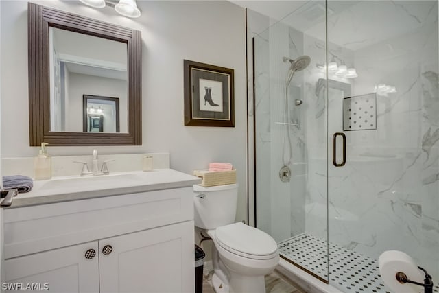 full bath featuring toilet, vanity, and a marble finish shower