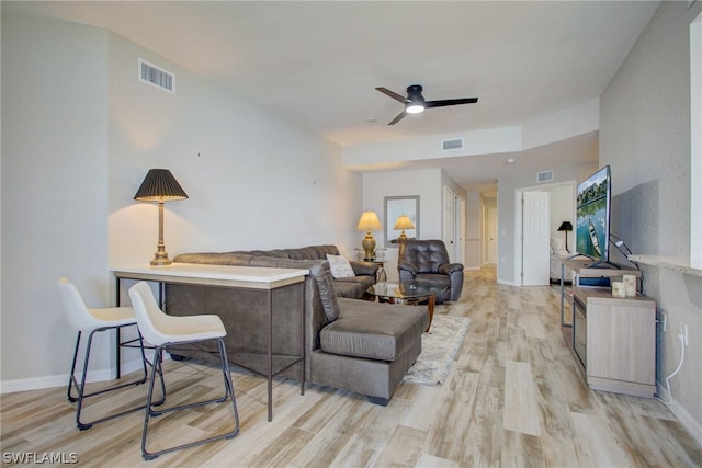 living area with light wood-style flooring and visible vents