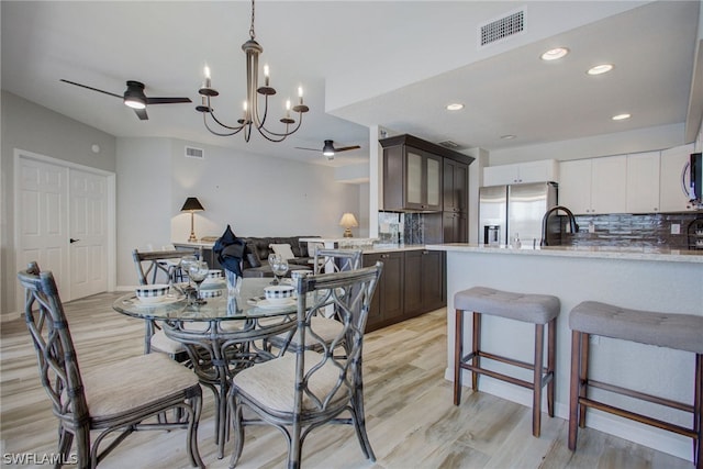 dining space with light wood-type flooring, visible vents, a ceiling fan, and recessed lighting