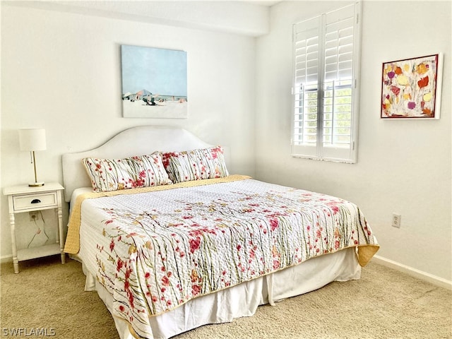 bedroom featuring carpet flooring and baseboards