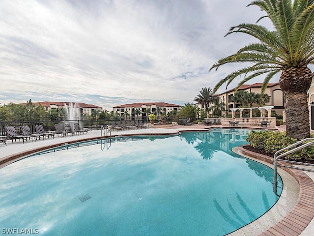 view of swimming pool featuring fence