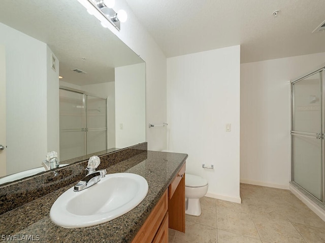 bathroom with toilet, a shower stall, visible vents, and vanity